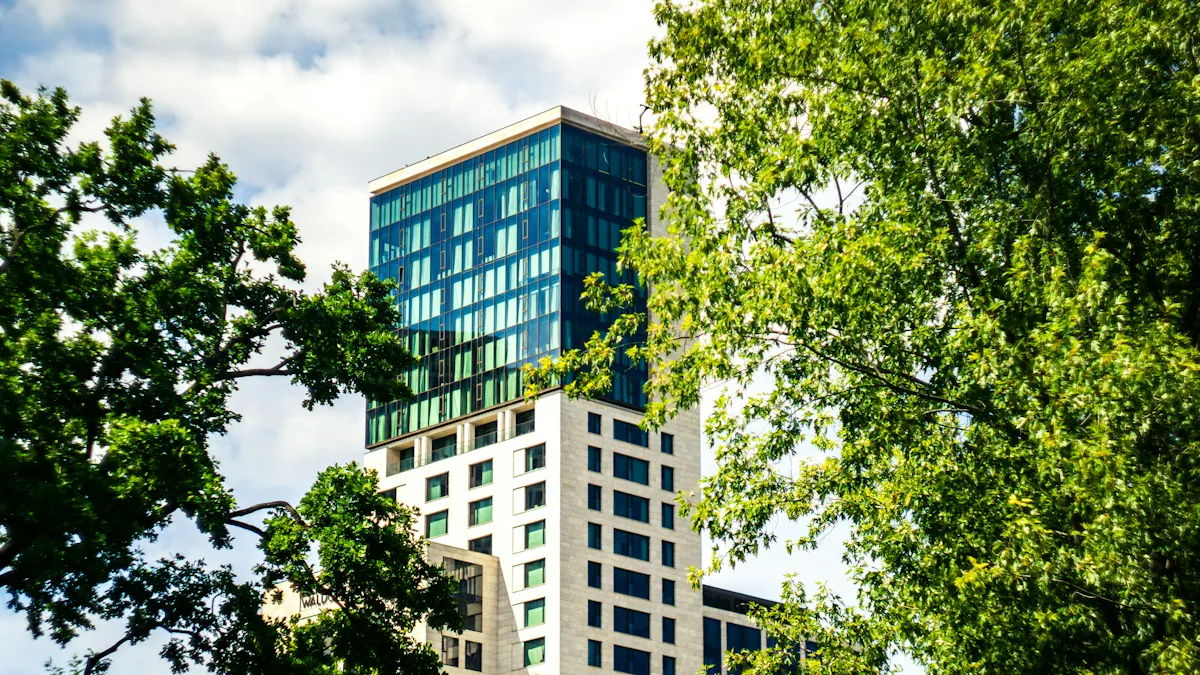 A glass tower framed by bright green leaves